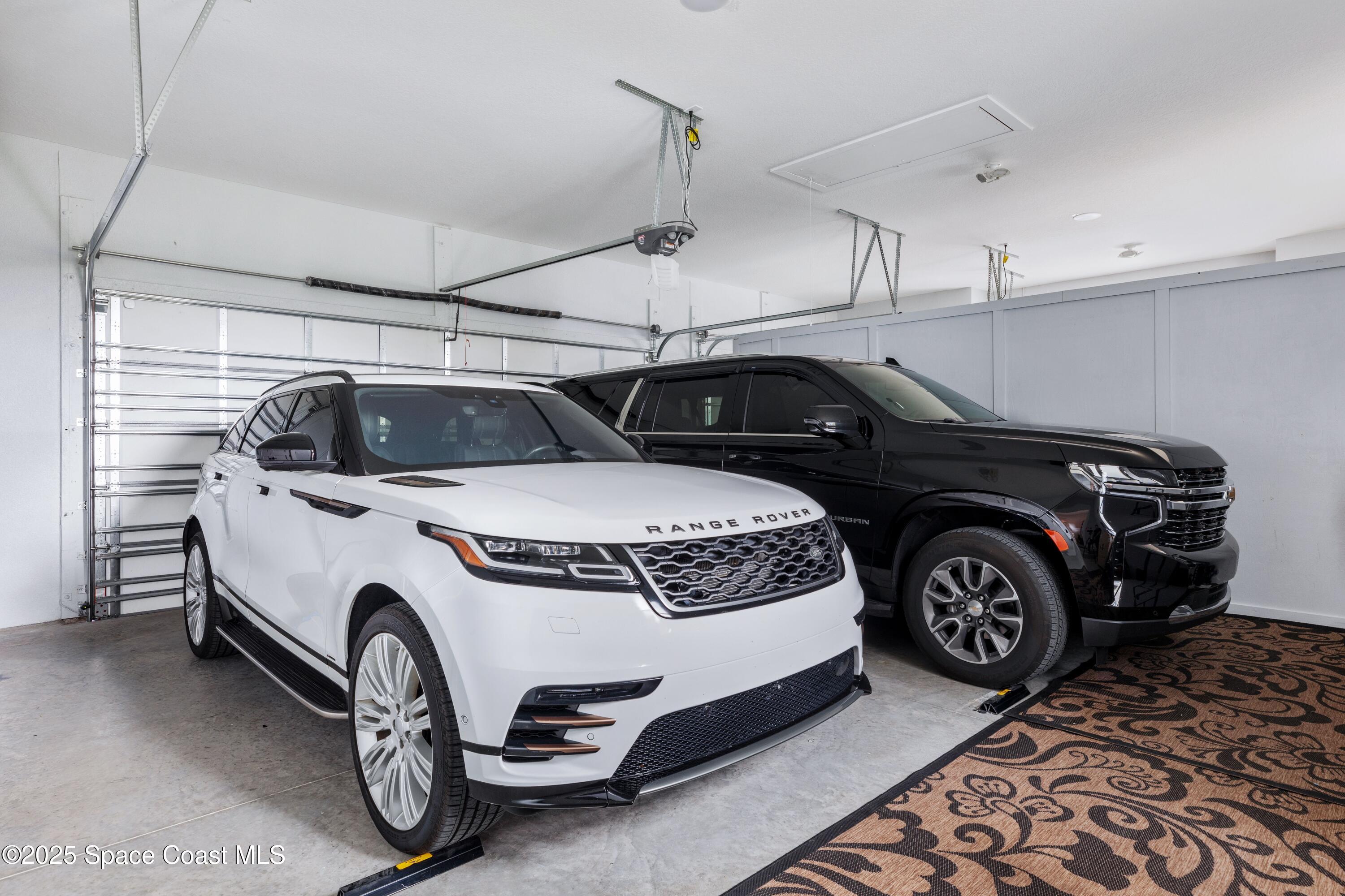 1420 Corey Road Malabar, FL 32950 - Photo 31 of 35 a car and a car parked in a garage