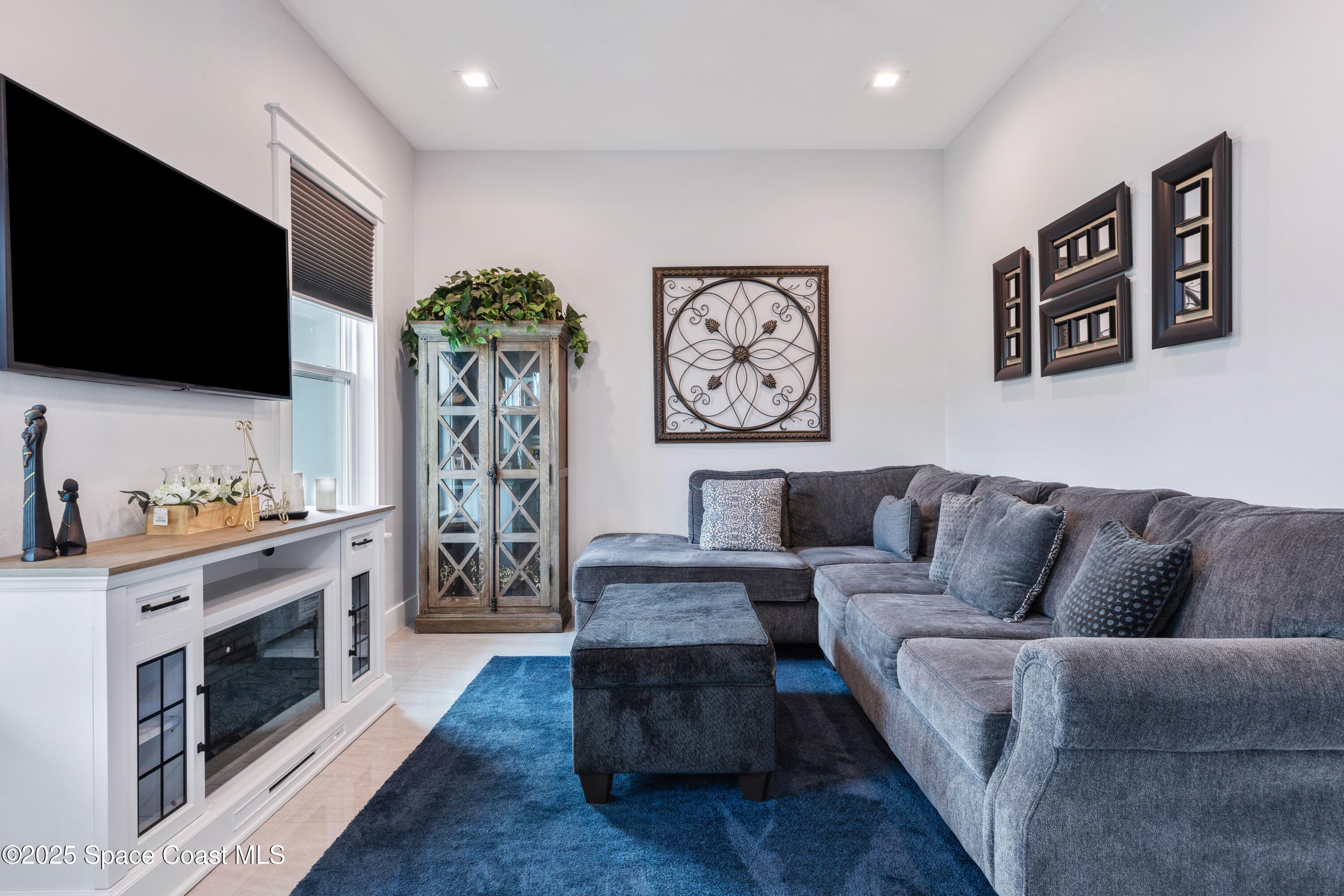 1420 Corey Road Malabar, FL 32950 - Photo 5 of 35 a living room with furniture and a flat screen tv