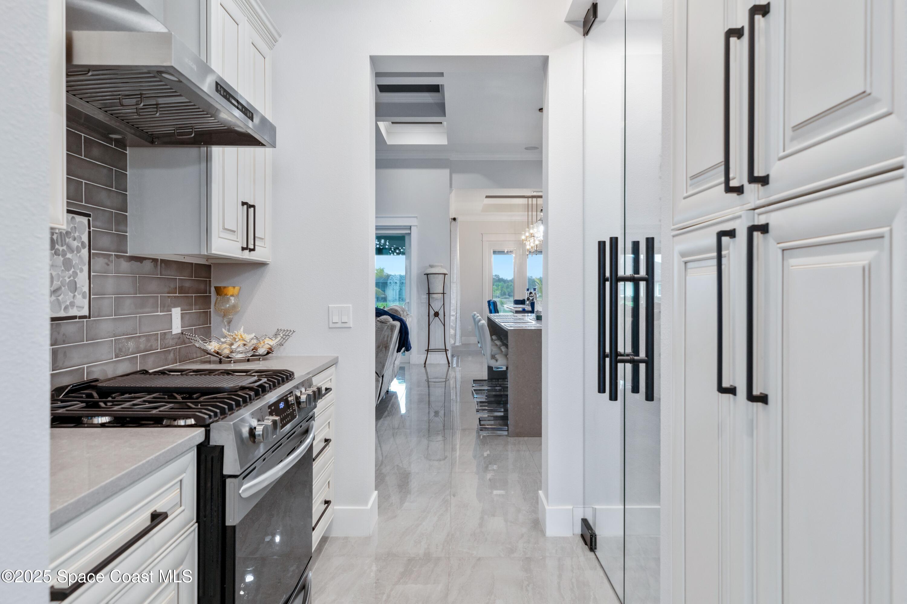 1420 Corey Road Malabar, FL 32950 - Photo 8 of 35 a kitchen with white cabinets and appliances