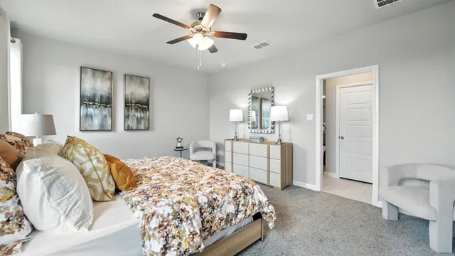 a bedroom with a large bed and a window