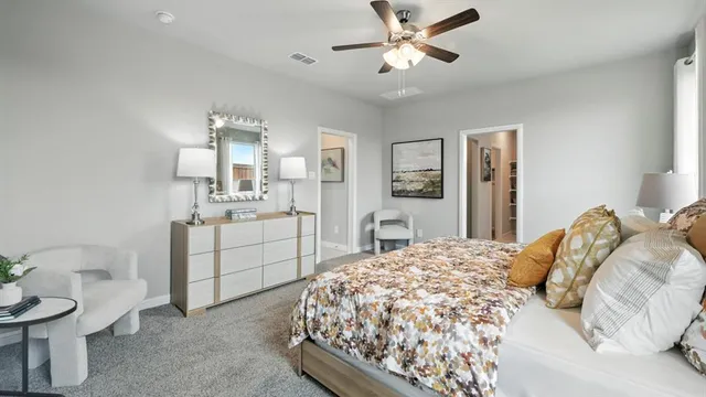 a bedroom with a large bed and a chandelier