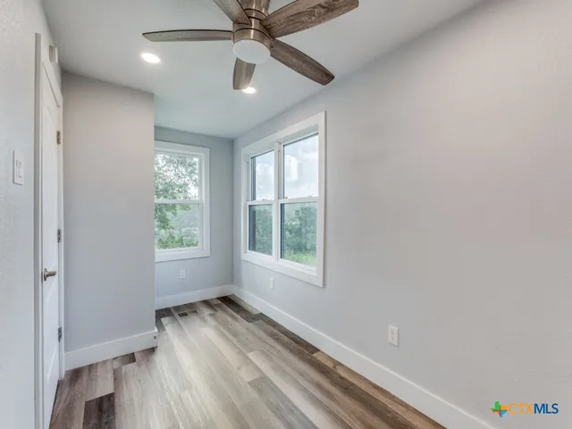 wooden floor in an empty room with a window