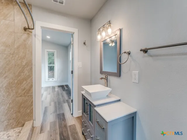 a bathroom with a sink and a mirror