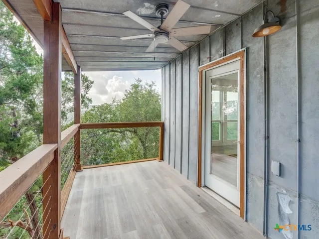 a view of balcony with wooden floor and fence