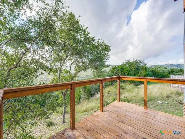 a view of balcony with wooden floor and fence