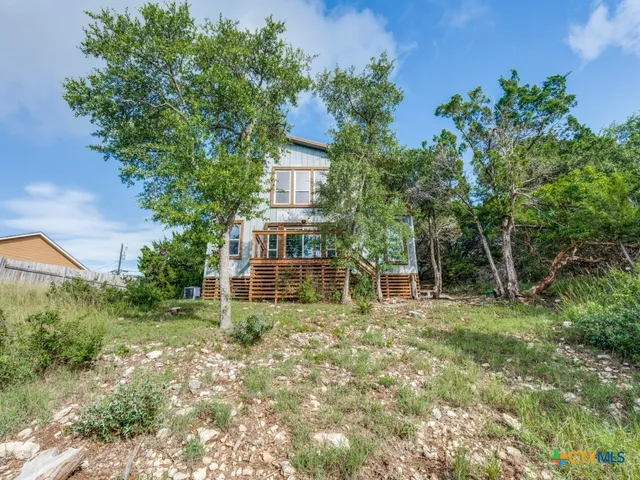 front view of a house with a tree