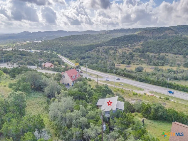 a sign of golf club on a wall under a tree