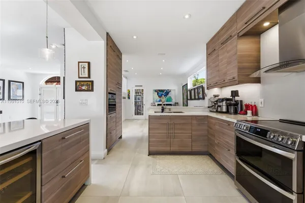 a large kitchen with stainless steel appliances granite countertop a stove and a sink