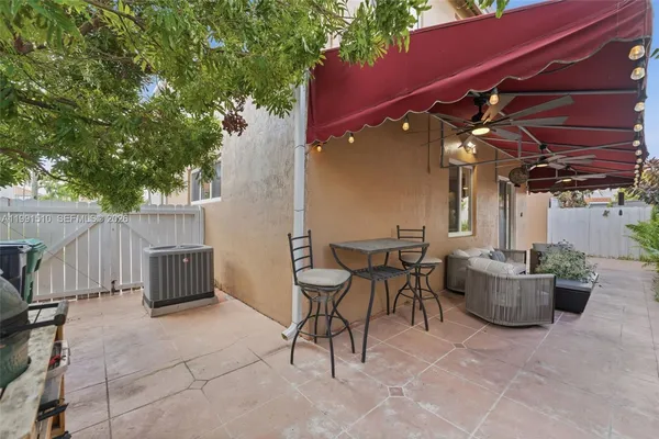 a view of a patio with couches and potted plants