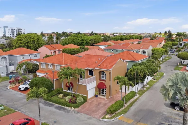 an aerial view of residential houses with outdoor space and street view