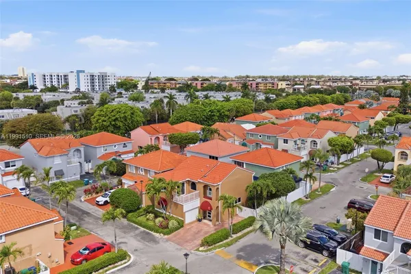 an aerial view of residential houses with outdoor space