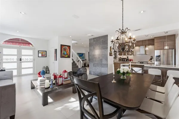 a dining room with furniture and chandelier