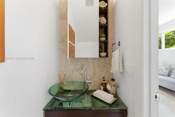 a bathroom with a sink and a mirror
