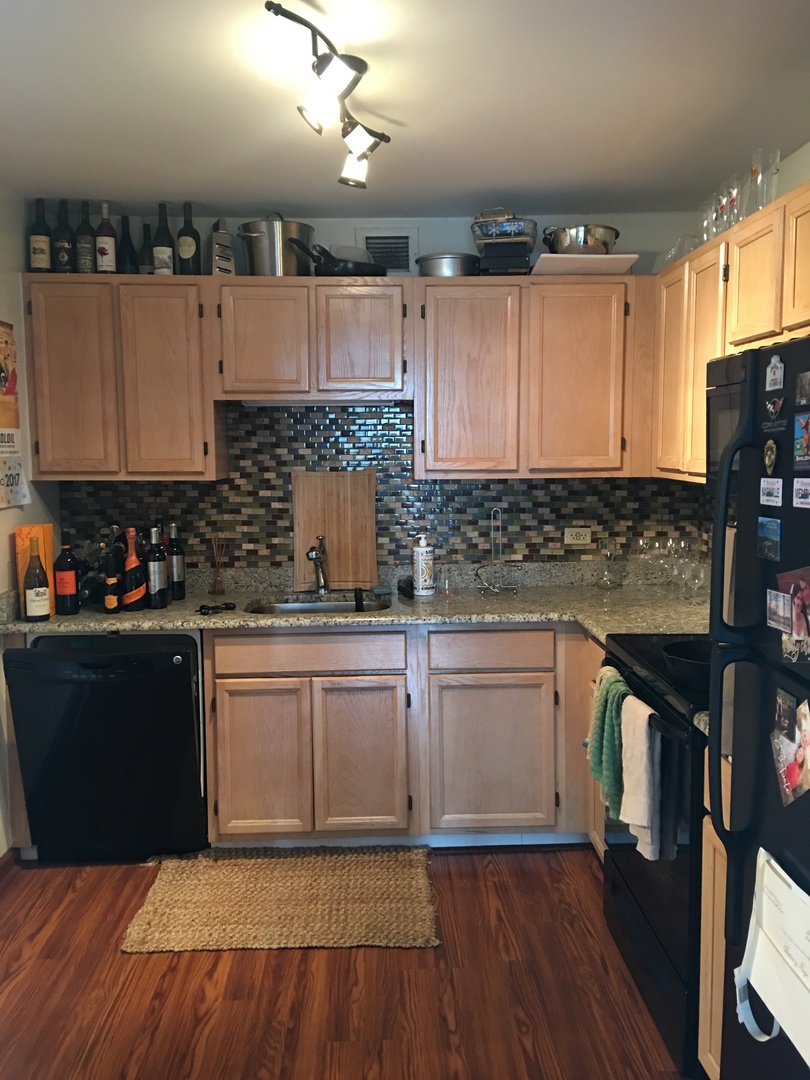 200 North Dearborn Street, Unit 2002 Chicago, IL 60601 - Photo 3 of 11 a kitchen with granite countertop a sink cabinets and stainless steel appliances