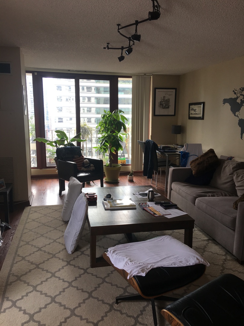 200 North Dearborn Street, Unit 2002 Chicago, IL 60601 - Photo 4 of 11 a living room with furniture and a large window