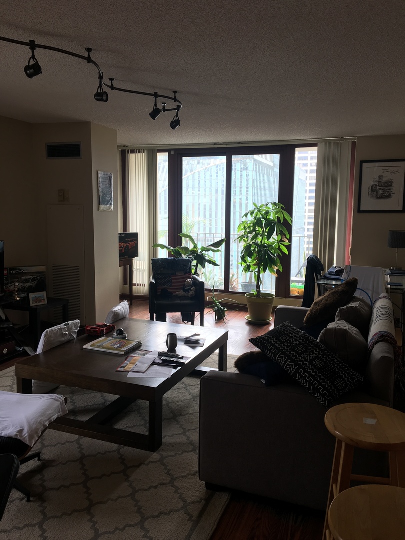 200 North Dearborn Street, Unit 2002 Chicago, IL 60601 - Photo 6 of 11 a living room with furniture and a large window