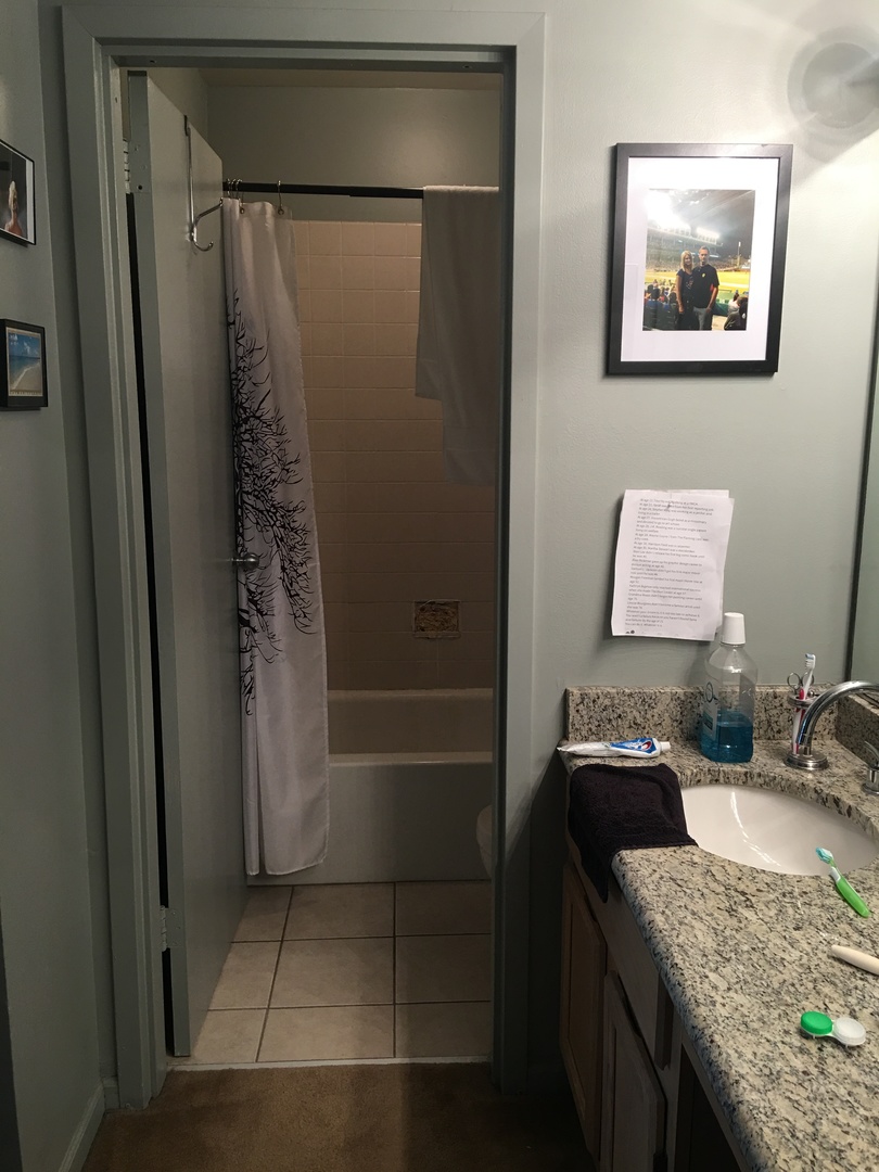 200 North Dearborn Street, Unit 2002 Chicago, IL 60601 - Photo 8 of 11 a bathroom with a granite countertop shower and a sink