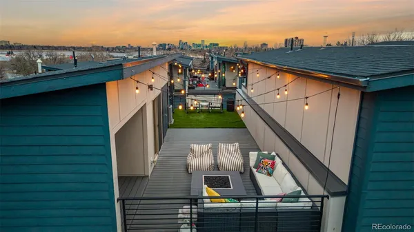 a view of roof deck with two chairs and a potted plant