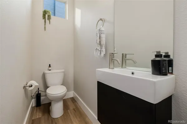 a bathroom with a sink toilet and mirror