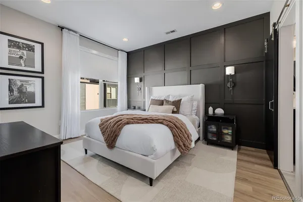 a bedroom with a bed and night stand