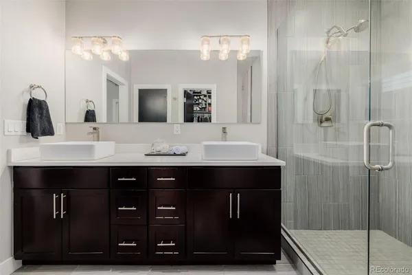 a bathroom with a sink double vanity and a mirror