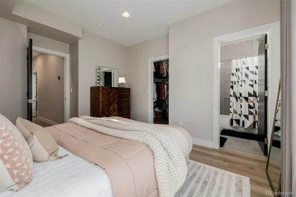 a bedroom with a bed and wooden floor