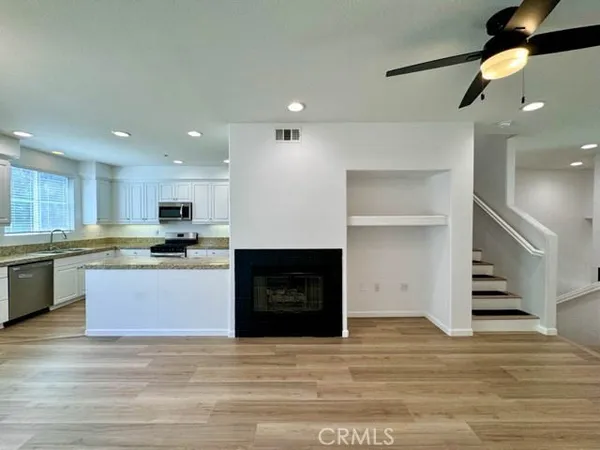 a large kitchen with stainless steel appliances kitchen island a large counter top and stove top oven