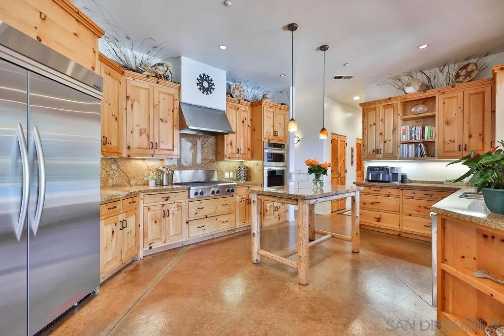 15775 Castle Peak Lane Jamul, CA 91935 - Photo 14 of 56 a kitchen with white cabinets and refrigerator