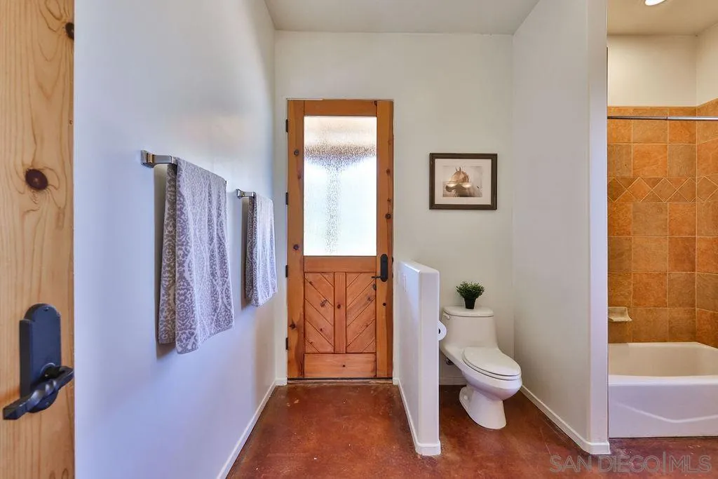15775 Castle Peak Lane Jamul, CA 91935 - Photo 23 of 56 a bathroom with a toilet sink and shower