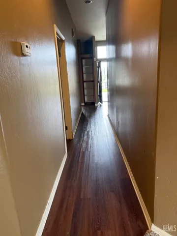 a view of hallway with wooden floor