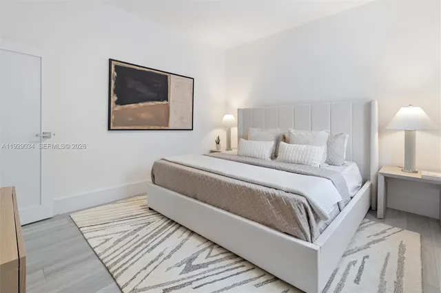 a bedroom with a bed and a lamp on table