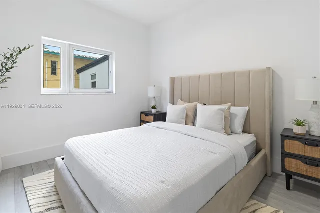 a bedroom with a bed and a painting