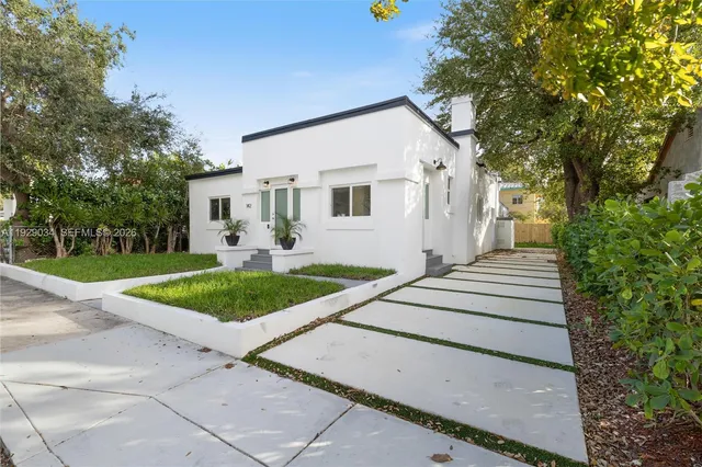 a front view of a house with garden
