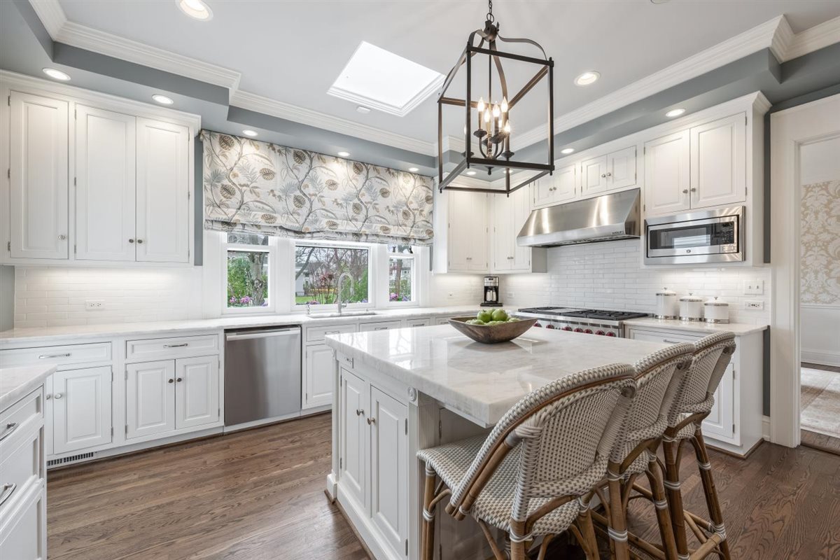 307 Abbotsford Road Kenilworth, IL 60043 - Photo 13 of 57 a kitchen with stainless steel appliances granite countertop a stove a sink a refrigerator a stove a dining table and chairs with wooden floor