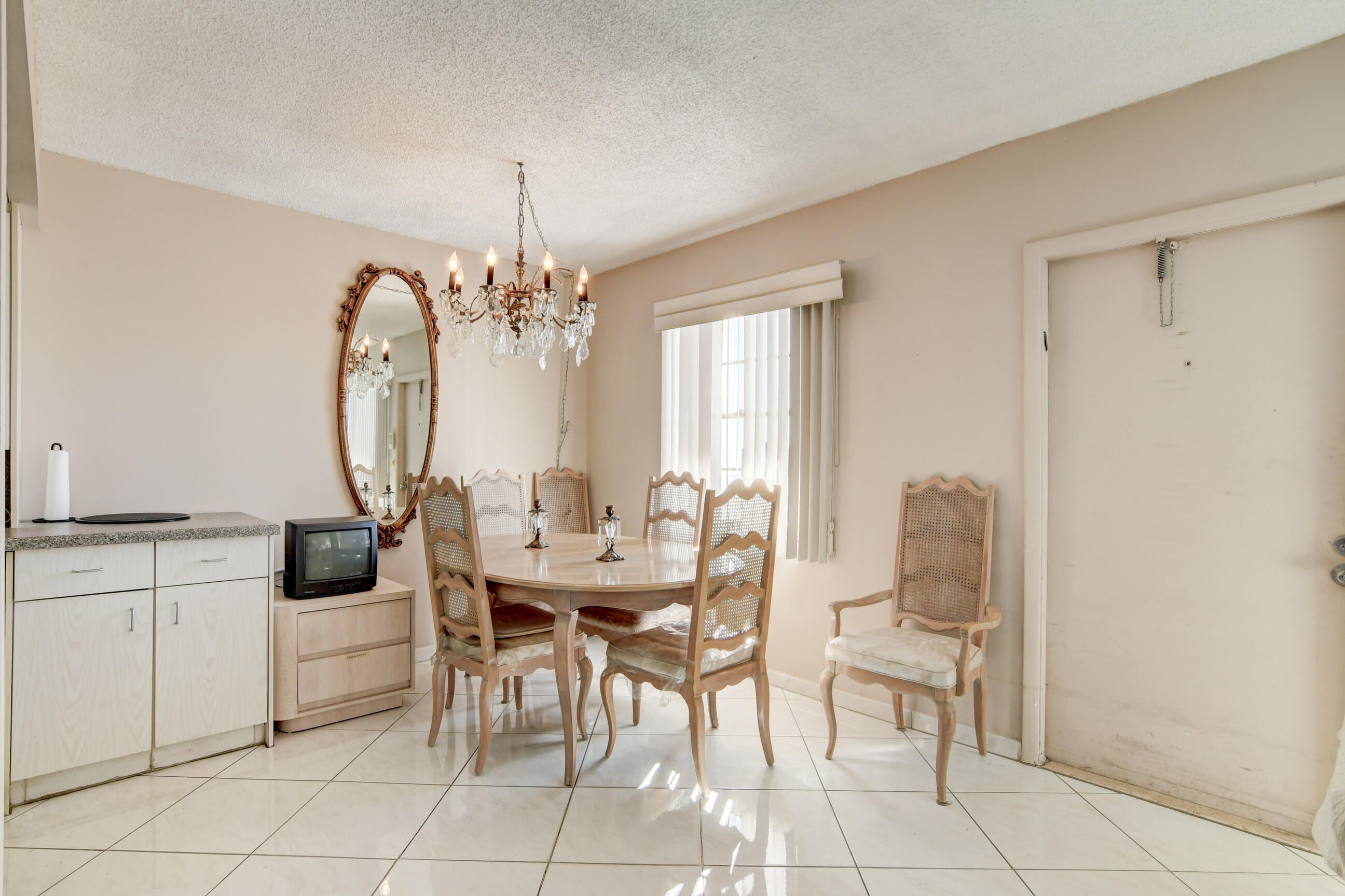 4044 Exeter C Boca Raton, FL 33434 - Photo 14 of 69 a view of a dining room with furniture and chandelier
