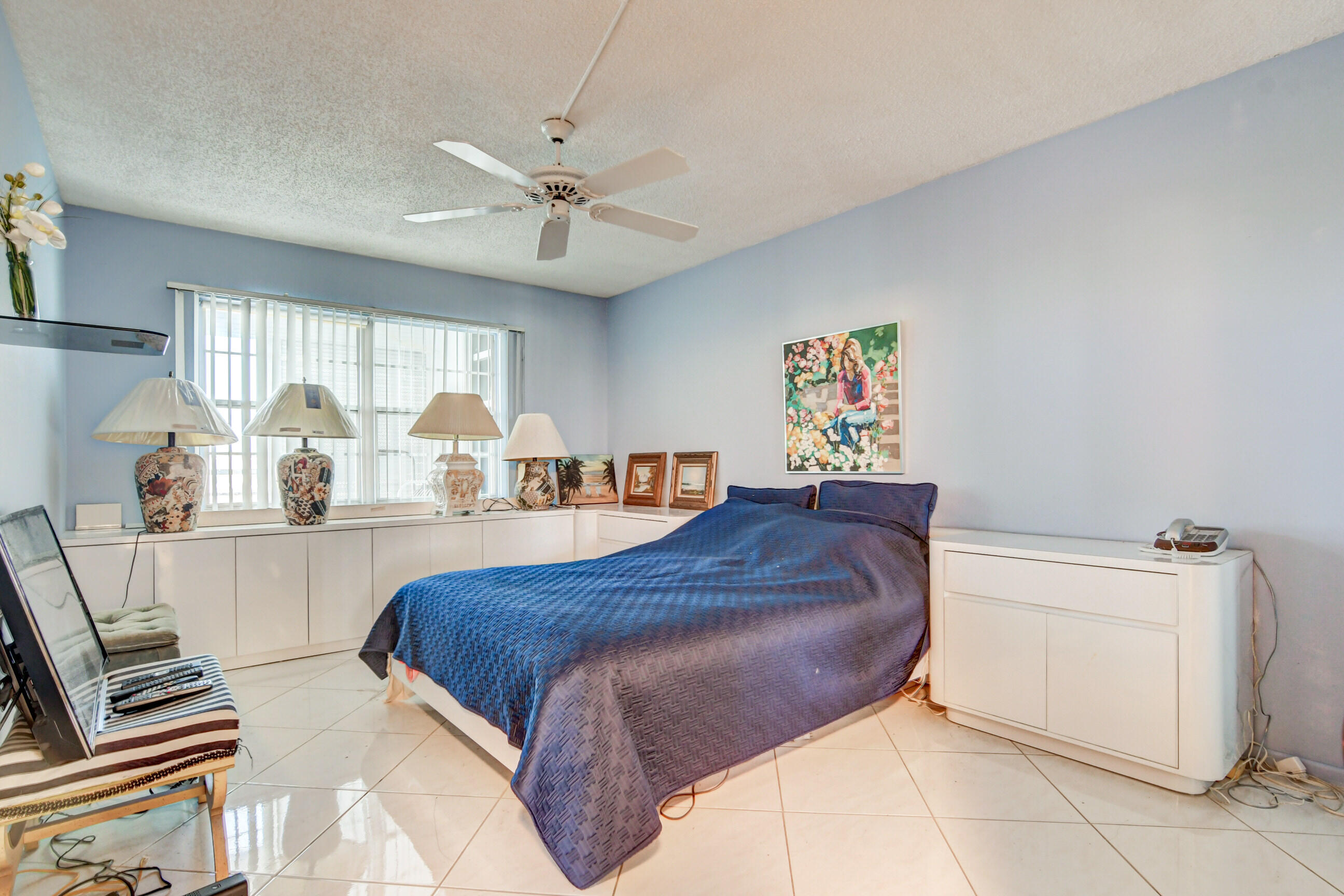 4044 Exeter C Boca Raton, FL 33434 - Photo 17 of 69 a bed room with a bed and a chandelier