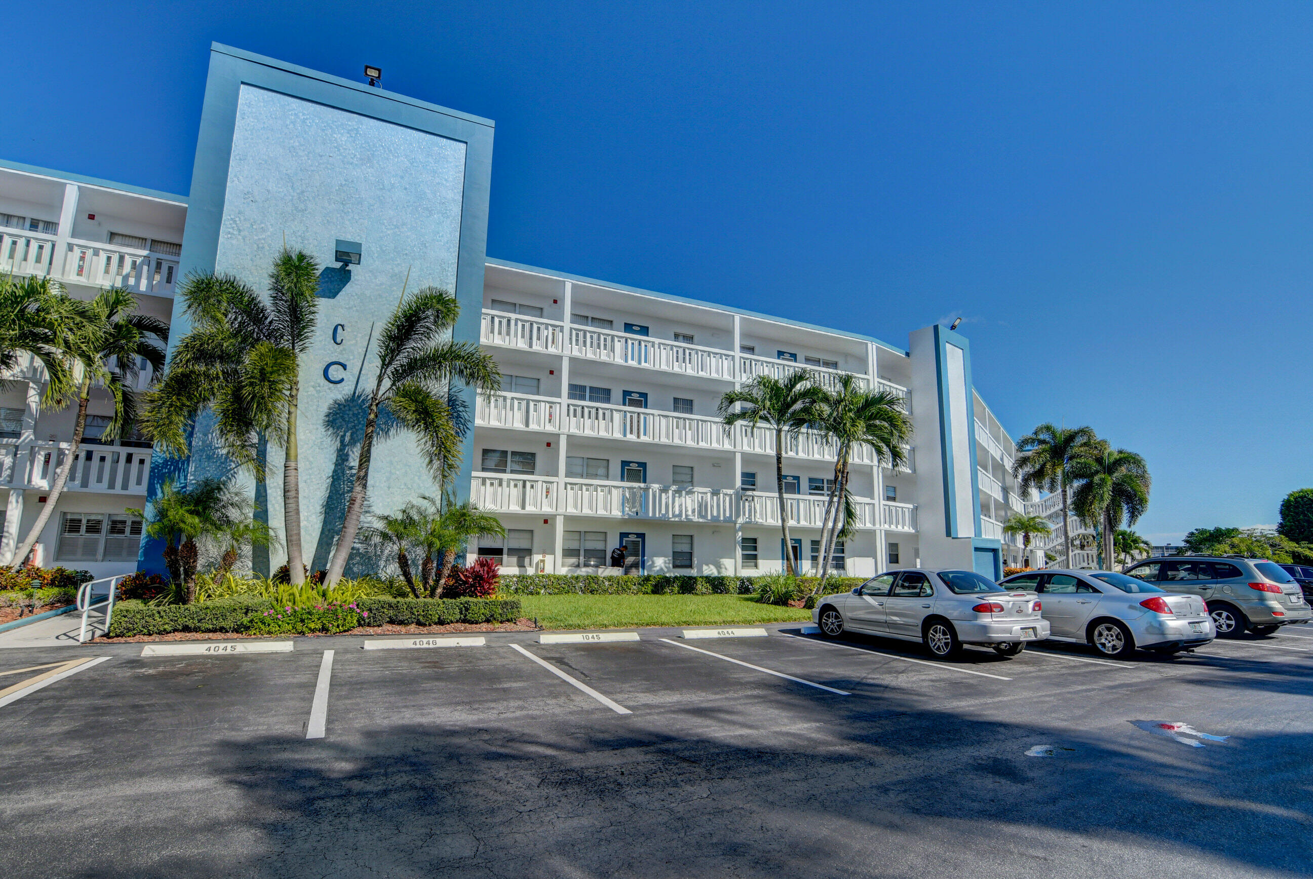 4044 Exeter C Boca Raton, FL 33434 - Photo 29 of 69 a car parked in front of a building with yard