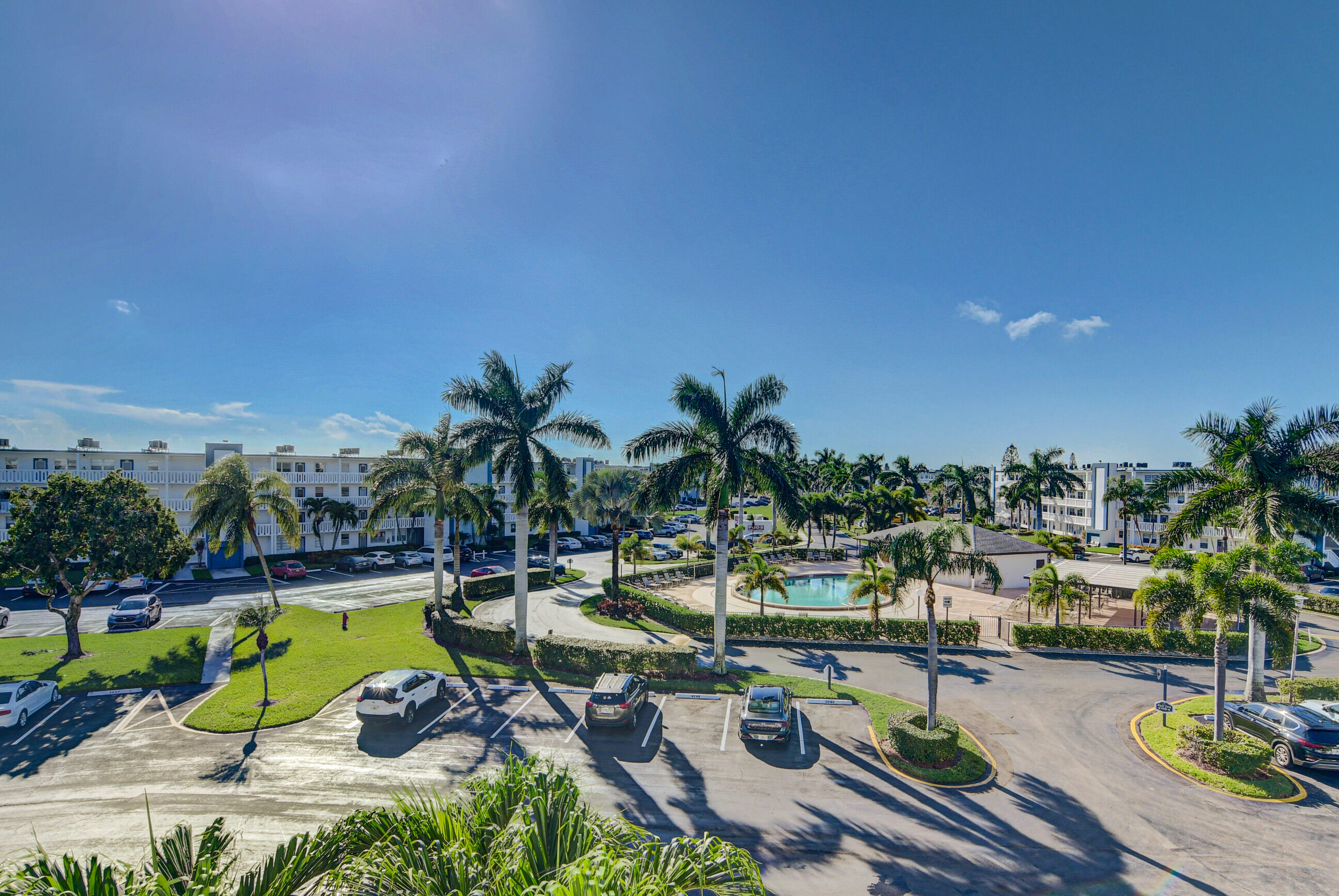 4044 Exeter C Boca Raton, FL 33434 - Photo 33 of 69 a view of a swimming pool and lounge chair