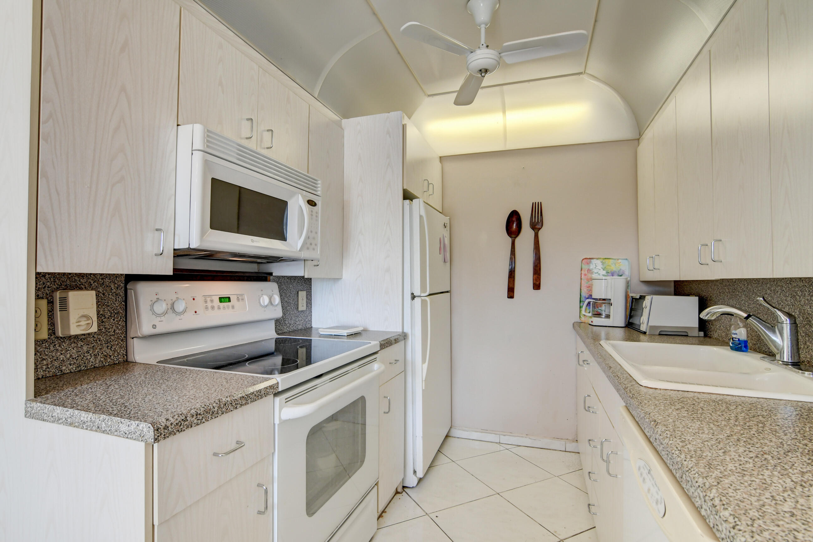4044 Exeter C Boca Raton, FL 33434 - Photo 5 of 69 a kitchen with granite countertop a sink a stove and cabinets
