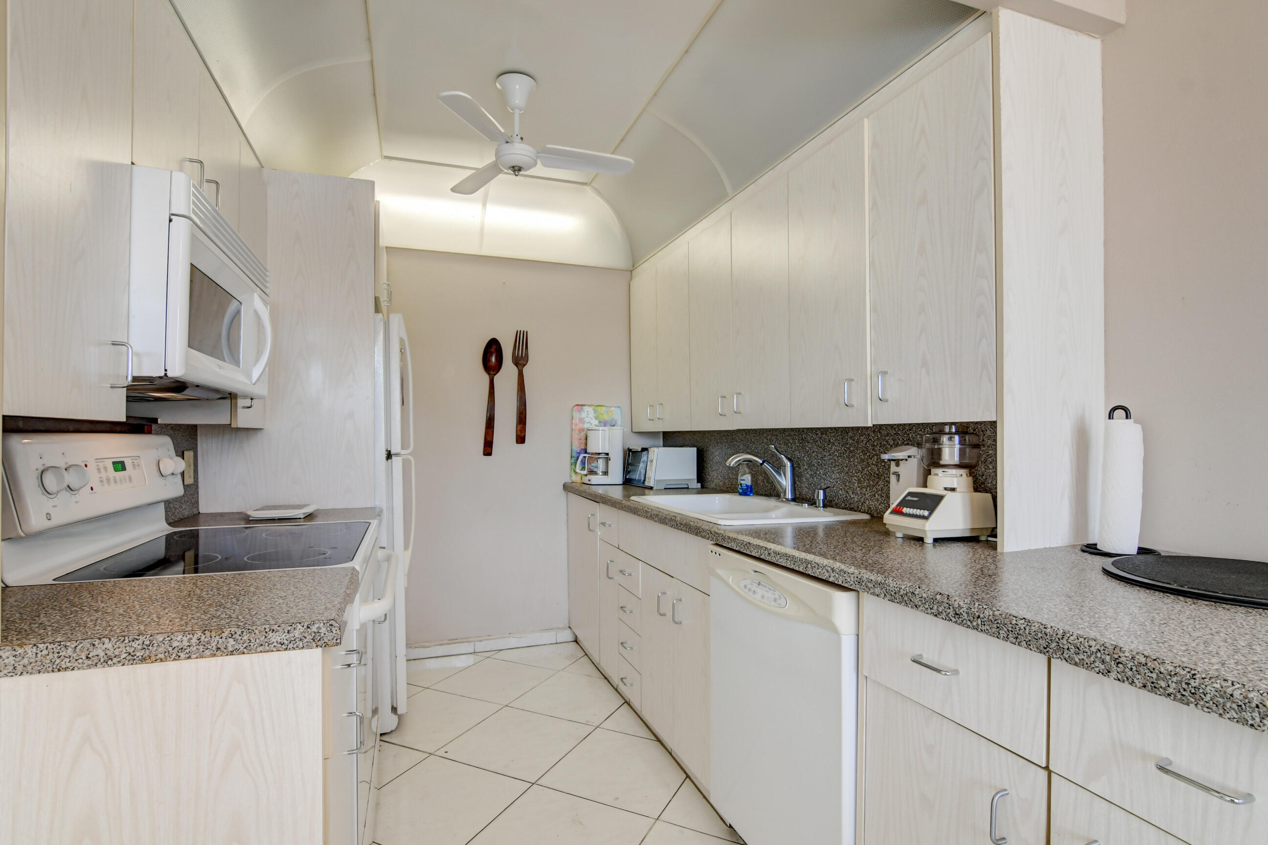4044 Exeter C Boca Raton, FL 33434 - Photo 6 of 69 a kitchen with granite countertop a sink a stove and cabinets
