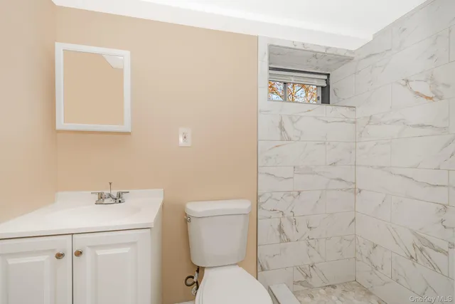 a view of a kitchen with white cabinets