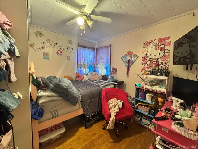 a living room with furniture a flat screen tv and a chandelier