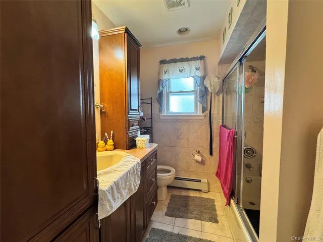 a bathroom with a bathtub sink and a mirror