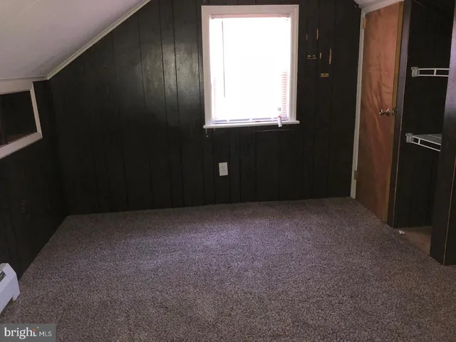 a view of an empty room and a window