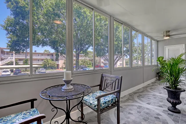 a backyard of a building with plants and trees