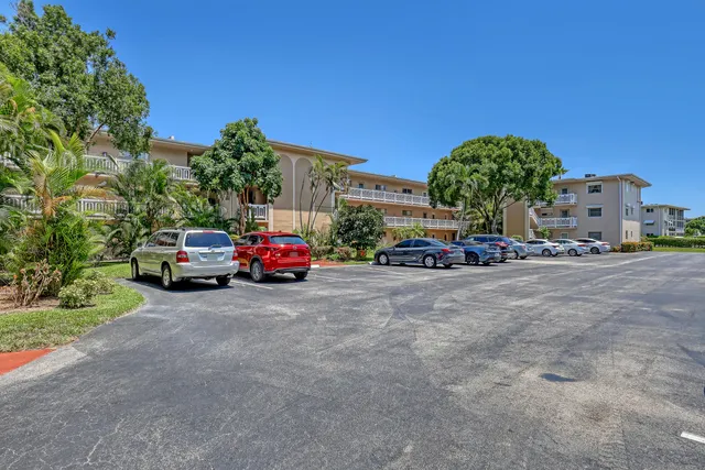 a view of a hallway with wooden floor and closet