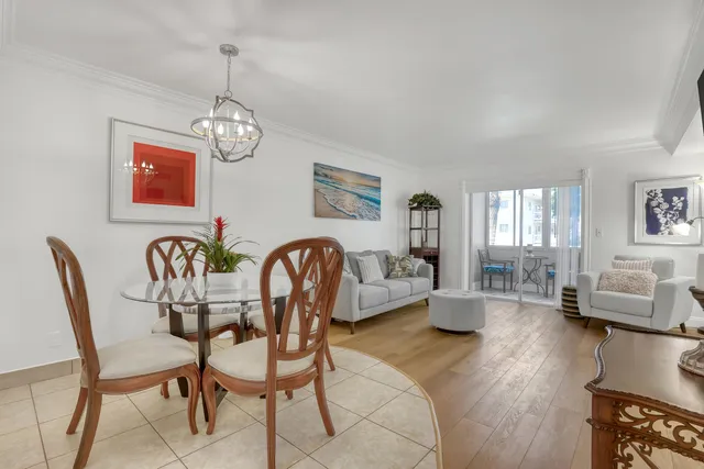 a view of a dining room with furniture wooden floor and chandelier