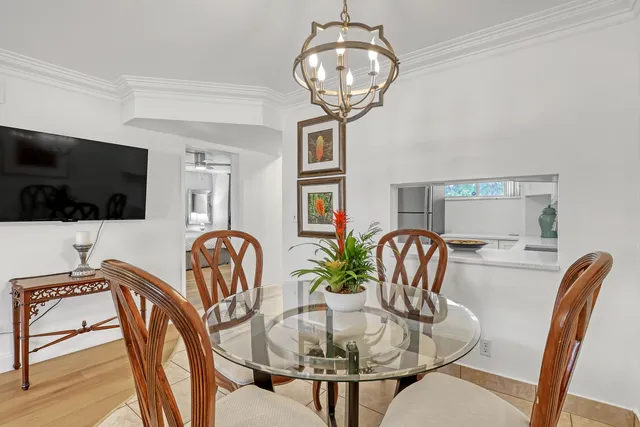 a dining room with furniture a chandelier and wooden floor
