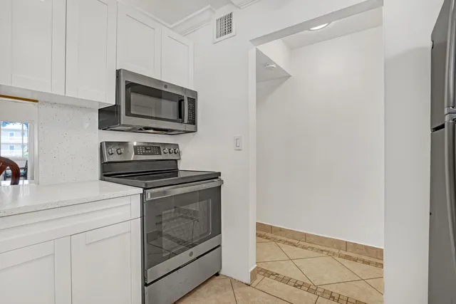 a white refrigerator freezer sitting in a kitchen