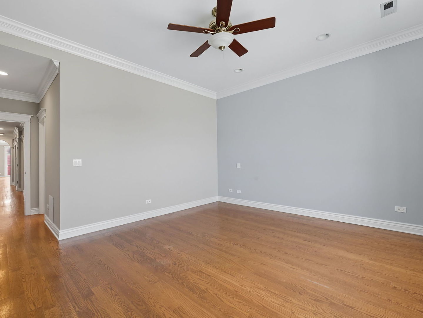 1248 West Jackson Boulevard, Unit 4W Chicago, IL 60607 - Photo 14 of 24 an empty room with a ceiling fan and wooden floor